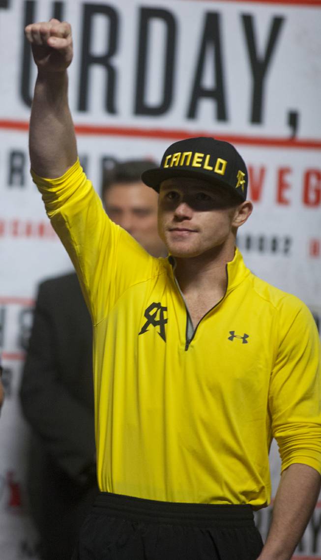Super welterweight Canelo Alvarez of Mexico greets the fans as he steps up on stage at the MGM Grand Arena on Friday, March 07, 2014.
